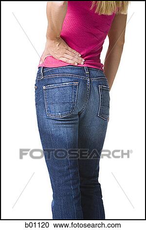 Mid section view of a young woman holding her waist View Large Photo Image Stock Image - Mid section view of a young woman holding her waist. Fotosearch