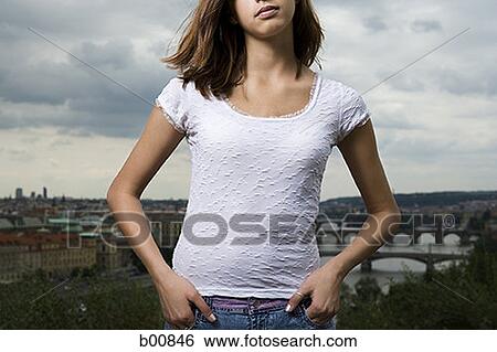 Stock Photograph - Mid section view of a young woman standing. Fotosearch
