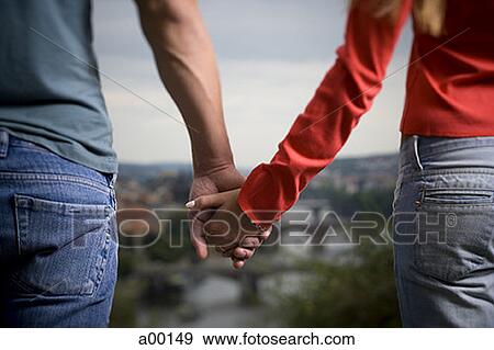 Mid section view of man and woman holding hands View Large Photo Image Stock Photo - Mid section view of man and woman holding hands. Fotosearch
