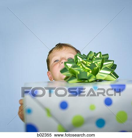 Portrait of a baby boy behind a gift View Large Photo Image Stock Photography - Portrait of a baby boy behind a gift. Fotosearch
