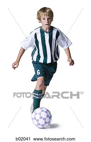 Portrait of a boy dribbling a soccer ball View Large Photo Image Stock Image - Portrait of a boy dribbling a soccer ball. Fotosearch