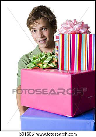 Portrait of a boy holding gifts View Large Photo Image Stock Photography - Portrait of a boy holding gifts. Fotosearch