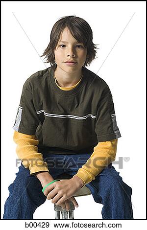 Portrait of a boy sitting on a stool View Large Photo Image Stock Photo - Portrait of a boy sitting on a stool. Fotosearch