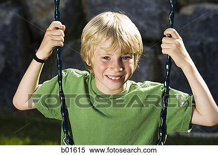Portrait of a boy sitting on a swing View Large Photo Image Stock Photography - Portrait of a boy sitting on a swing. Fotosearch