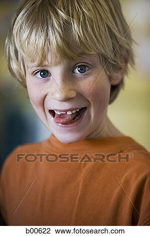 Portrait of a boy sticking out his tongue View Large Photo Image Stock Image - Portrait of a boy sticking out his tongue. Fotosearch
