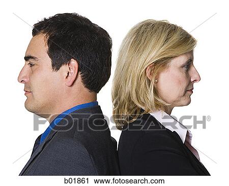 Portrait of a businessman and a businesswoman standing back to back View Large Photo Image Stock Image - Portrait of a businessman and a businesswoman standing back to back. Fotosearch