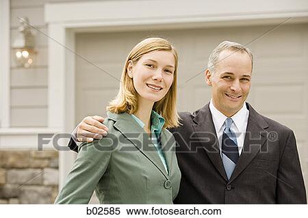 Portrait of a businessman and a businesswoman smiling View Large Photo Image Stock Photography - Portrait of a businessman and a businesswoman smiling. Fotosearch