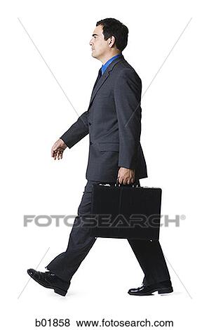Portrait of a businessman carrying a briefcase View Large Photo Image Stock Photo - Portrait of a businessman carrying a briefcase. Fotosearch