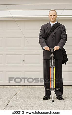 Portrait of a businessman holding a pogo stick View Large Photo Image Stock Image - Portrait of a businessman holding a pogo stick. Fotosearch