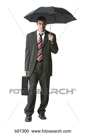 Portrait of a businessman holding a briefcase and an umbrella View Large Photo Image Stock Image - Portrait of a businessman holding a briefcase and an umbrella. Fotosearch