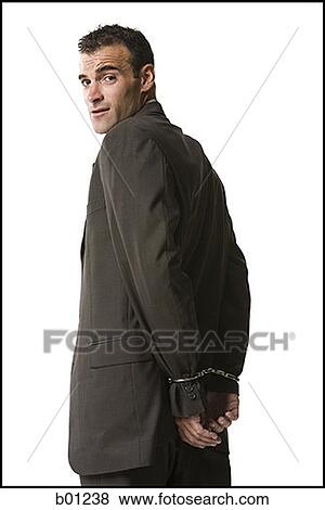 Portrait of a businessman in handcuffs View Large Photo Image Stock Photo - Portrait of a businessman in handcuffs. Fotosearch