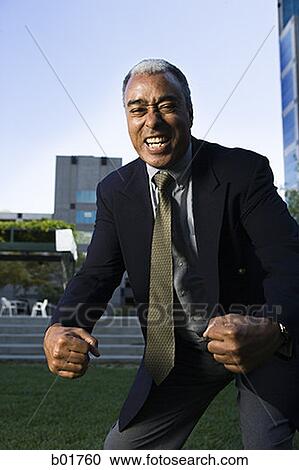 Portrait of a businessman making fists in excitement View Large Photo Image Stock Image - Portrait of a businessman making fists in excitement. Fotosearch