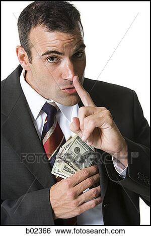 Stock Photograph - Portrait of a businessman putting money in his jacket. Fotosearch