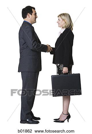 Portrait of a businessman shaking hands with a businesswoman View Large Photo Image Stock Image - Portrait of a businessman shaking hands with a businesswoman. Fotosearch