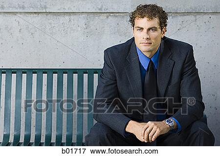 Portrait of a businessman sitting on a bench View Large Photo Image Stock Photo - Portrait of a businessman sitting on a bench. Fotosearch