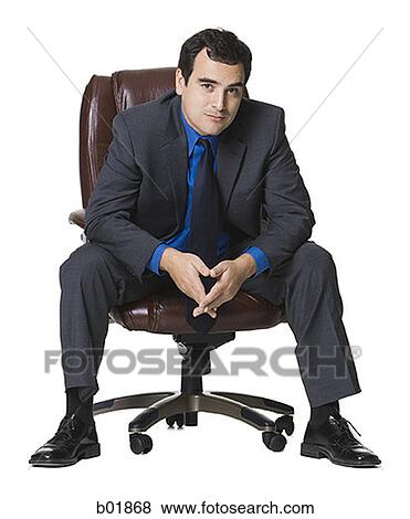 Portrait of a businessman sitting on an armchair View Large Photo Image Stock Photo - Portrait of a businessman sitting on an armchair. Fotosearch