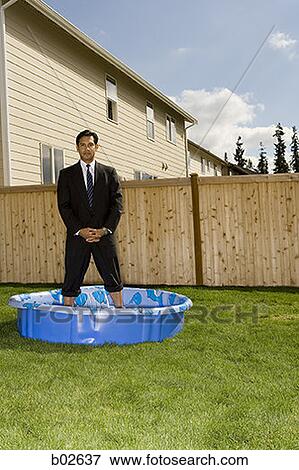 Portrait of a businessman standing in a wading pool View Large Photo Image Stock Photo - Portrait of a businessman standing in a wading pool. Fotosearch