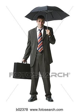 Portrait of a businessman standing with a briefcase and umbrella View Large Photo Image Stock Photo - Portrait of a businessman standing with a briefcase and umbrella. Fotosearch