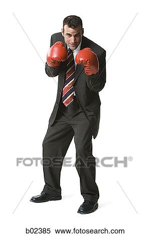 Portrait of a businessman wearing boxing gloves View Large Photo Image Stock Photography - Portrait of a businessman wearing boxing gloves. Fotosearch