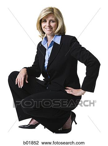 Portrait of a businesswoman crouching with her hand on her hip View Large Photo Image Stock Image - Portrait of a businesswoman crouching with her hand on her hip. Fotosearch