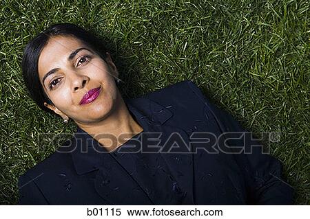 Portrait of a businesswoman lying on a lawn View Large Photo Image Stock Photography - Portrait of a businesswoman lying on a lawn. Fotosearch