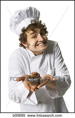 Portrait of a chef holding a muffin View Large Photo Image Stock Photography - Portrait of a chef holding a muffin. Fotosearch