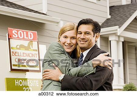 Portrait of a couple hugging in front of house with 'Sold' sign View Large Photo Image Stock Image - Portrait of a couple hugging in front of house with 'Sold' sign. Fotosearch