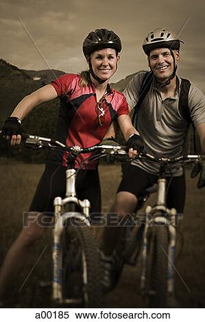 Portrait of a couple mountain biking View Large Photo Image Stock Photography - Portrait of a couple mountain biking. Fotosearch