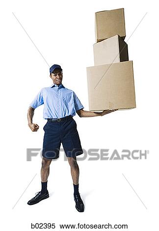 Portrait of a delivery man holding a stack of boxes View Large Photo Image Stock Photography - Portrait of a delivery man holding a stack of boxes. Fotosearch