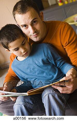 Stock Photograph - Portrait of a father reading to his son. Fotosearch