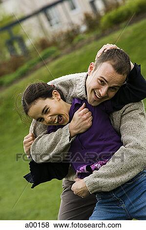 Portrait of a father with his daughter in a park View Large Photo Image Stock Photo - Portrait of a father with his daughter in a park. Fotosearch