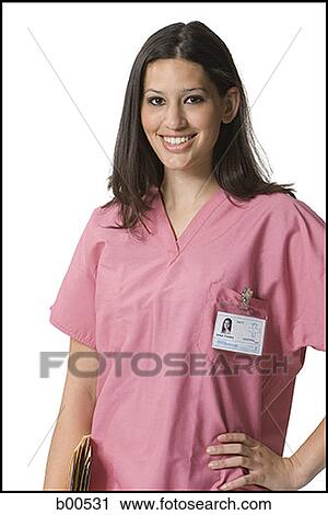 Stock Image - Portrait of a female nurse standing with her hand on her hip. Fotosearch