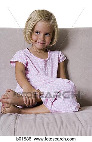 Portrait of a girl sitting on a couch View Large Photo Image Stock Photograph - Portrait of a girl sitting on a couch. Fotosearch