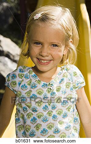 Portrait of a girl sitting on a slide View Large Photo Image Stock Image - Portrait of a girl sitting on a slide. Fotosearch