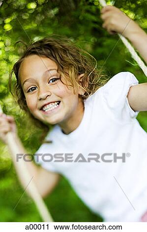 Portrait of a girl swinging on a swing View Large Photo Image Stock Image - Portrait of a girl swinging on a swing. Fotosearch