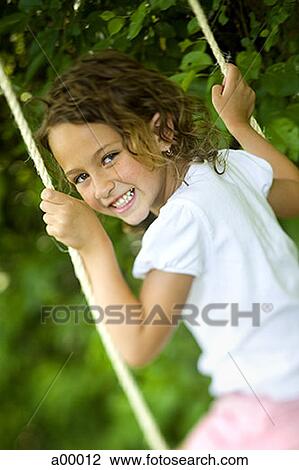 Portrait of a girl swinging on a swing View Large Photo Image Stock Image - Portrait of a girl swinging on a swing. Fotosearch