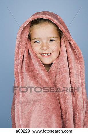 Stock Photo - Portrait of a girl wrapped in a blanket. Fotosearch