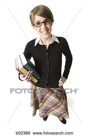 Portrait of a librarian holding books View Large Photo Image Stock Photo - Portrait of a librarian holding books. Fotosearch