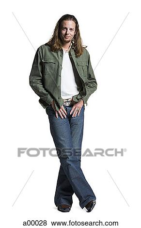 Portrait of a long-haired young man with his hands in his pockets View Large Photo Image Stock Photo - Portrait of a long-haired young man with his hands in his pockets. Fotosearch