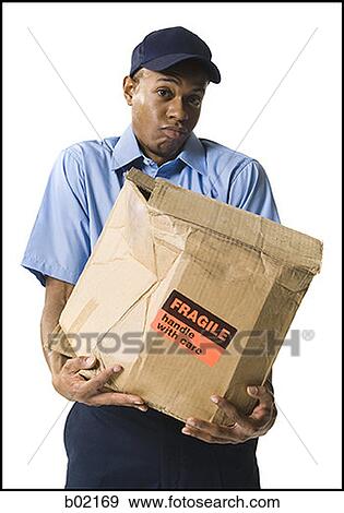 Portrait of a mailman holding a damaged package View Large Photo Image Stock Photo - Portrait of a mailman holding a damaged package. Fotosearch