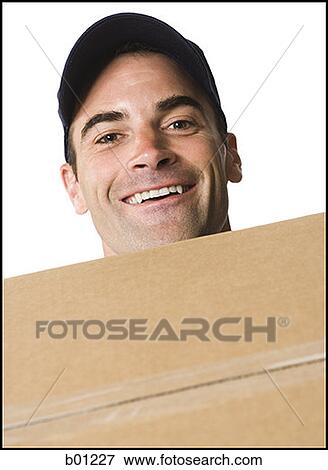 Portrait of a mailman smiling and holding a package View Large Photo Image Stock Photo - Portrait of a mailman smiling and holding a package. Fotosearch