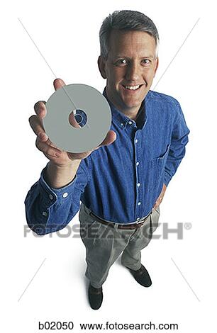 Portrait of a man holding a compact disc View Large Photo Image Stock Image - Portrait of a man holding a compact disc. Fotosearch