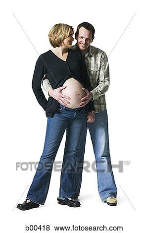 Portrait of a man touching his pregnant wife's abdomen View Large Photo Image Stock Photo - Portrait of a man touching his pregnant wife's abdomen. Fotosearch
