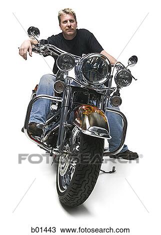 Stock Image - Portrait of a mature man sitting on a motorcycle. Fotosearch