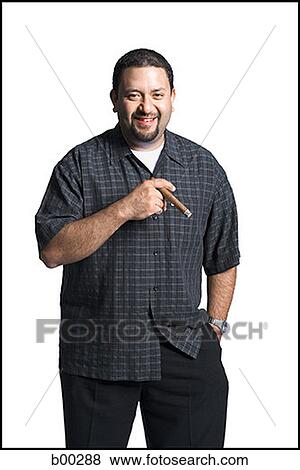Portrait of a mid adult man smiling holding a cigar View Large Photo Image Stock Photo - Portrait of a mid adult man smiling holding a cigar. Fotosearch