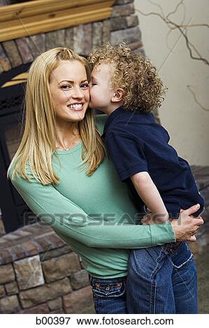 Stock Photo - Portrait of a mother being kissed by her son. Fotosearch