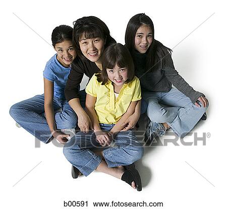 Portrait of a mother sitting with her three daughters View Large Photo Image Stock Image - Portrait of a mother sitting with her three daughters. Fotosearch