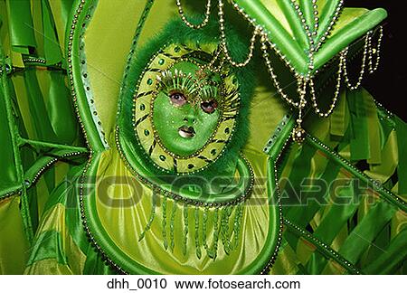 Stock Image - Portrait of a person standing in a masquerade costume. Fotosearch