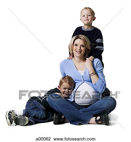 Stock Image - Portrait of a pregnant mother with her two sons. Fotosearch