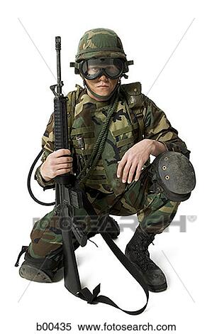 Portrait of a soldier kneeling and holding a rifle View Large Photo Image Stock Photography - Portrait of a soldier kneeling and holding a rifle. Fotosearch